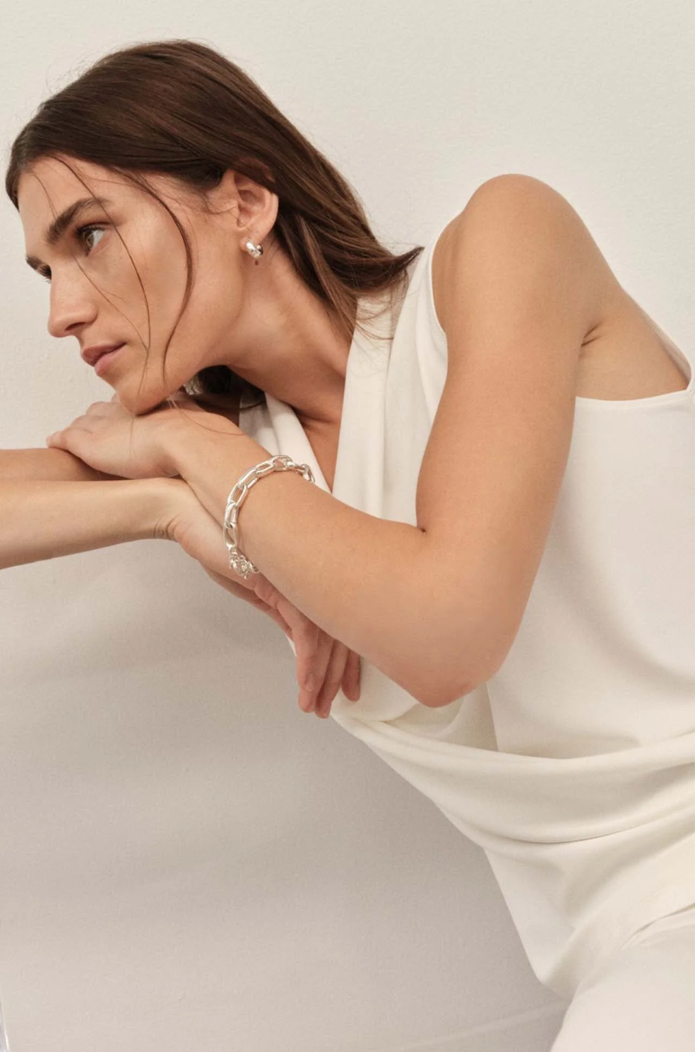 Woman wearing a white dress with a plain background