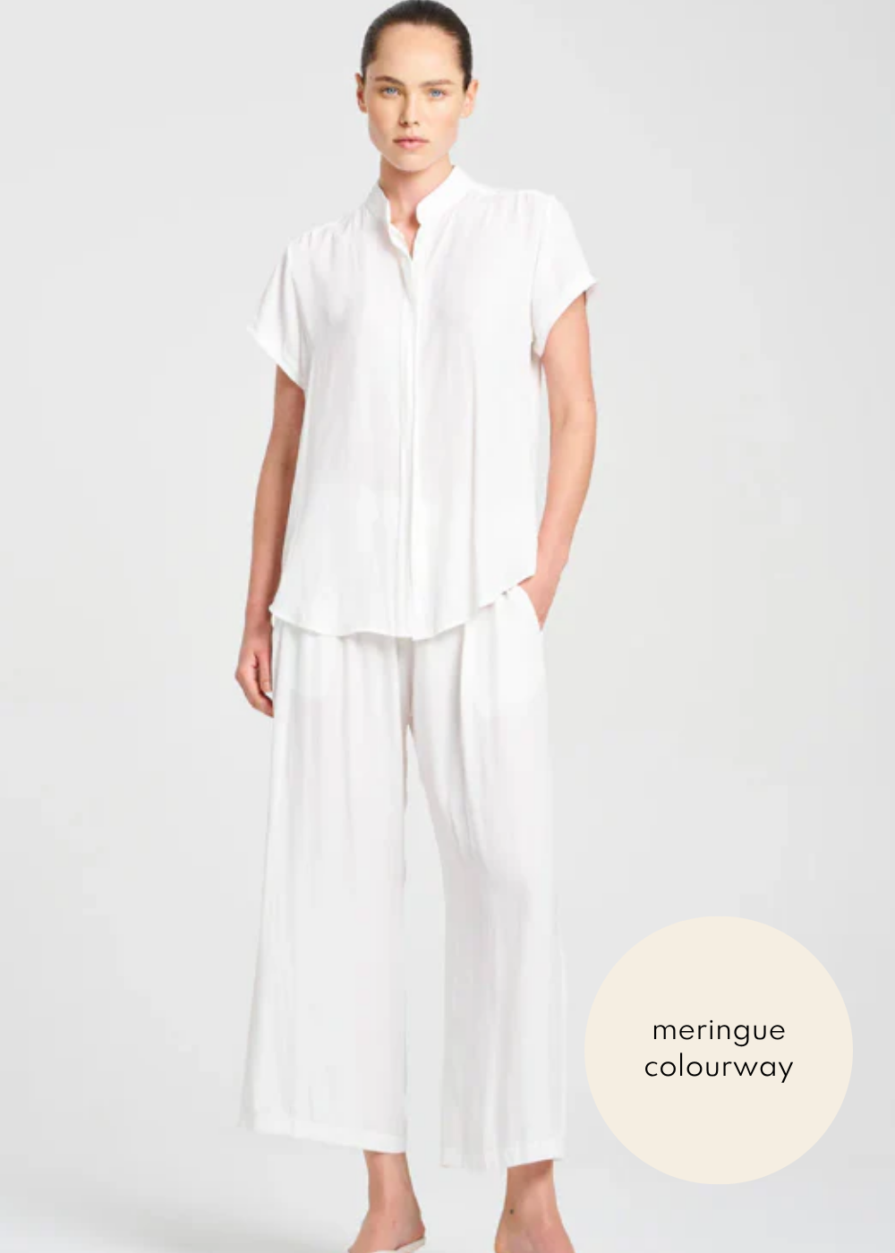 Woman wearing a white outfit with 'meringue colourway' label on a light gray background