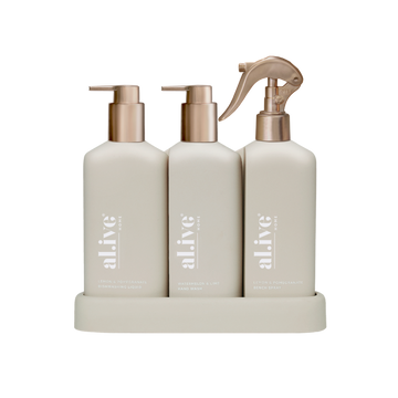 al.ive body Limited Edition Stone Kitchen Trio Bronze Edition with dishwashing liquid, hand wash and bench spray on a stone tray