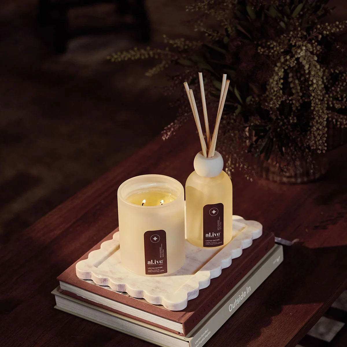 al.ive body Vanilla Cream & Tonka Bean Reed Diffuser and Soy Candle styled together on a scalloped tray