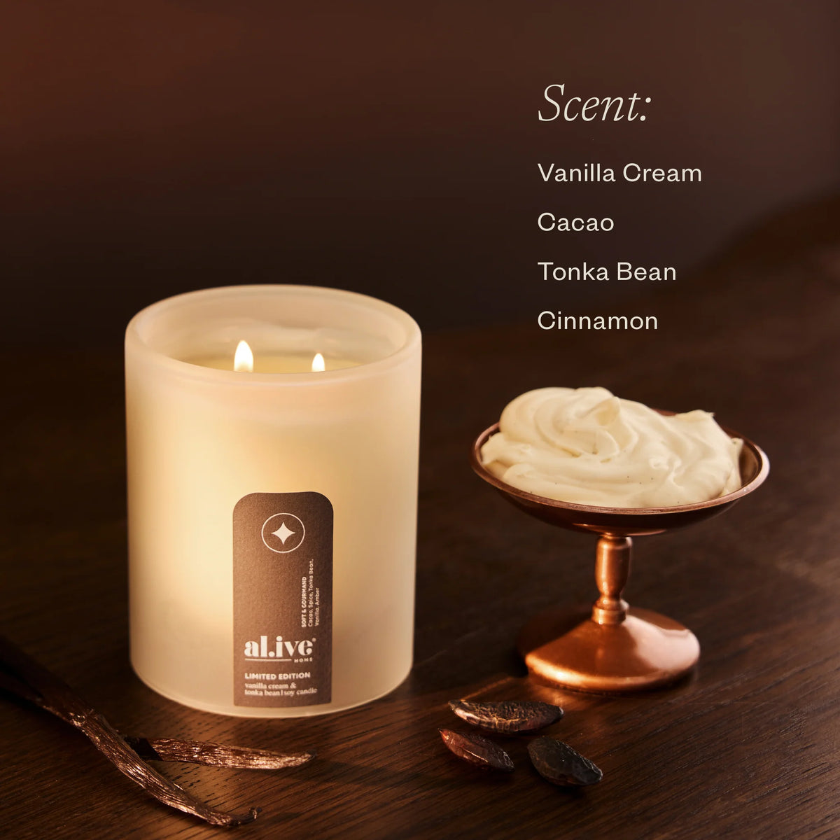 al.ive body Vanilla Cream & Tonka Bean Soy Candle lit, with scent notes of vanilla cream, cacao, tonka bean and cinnamon