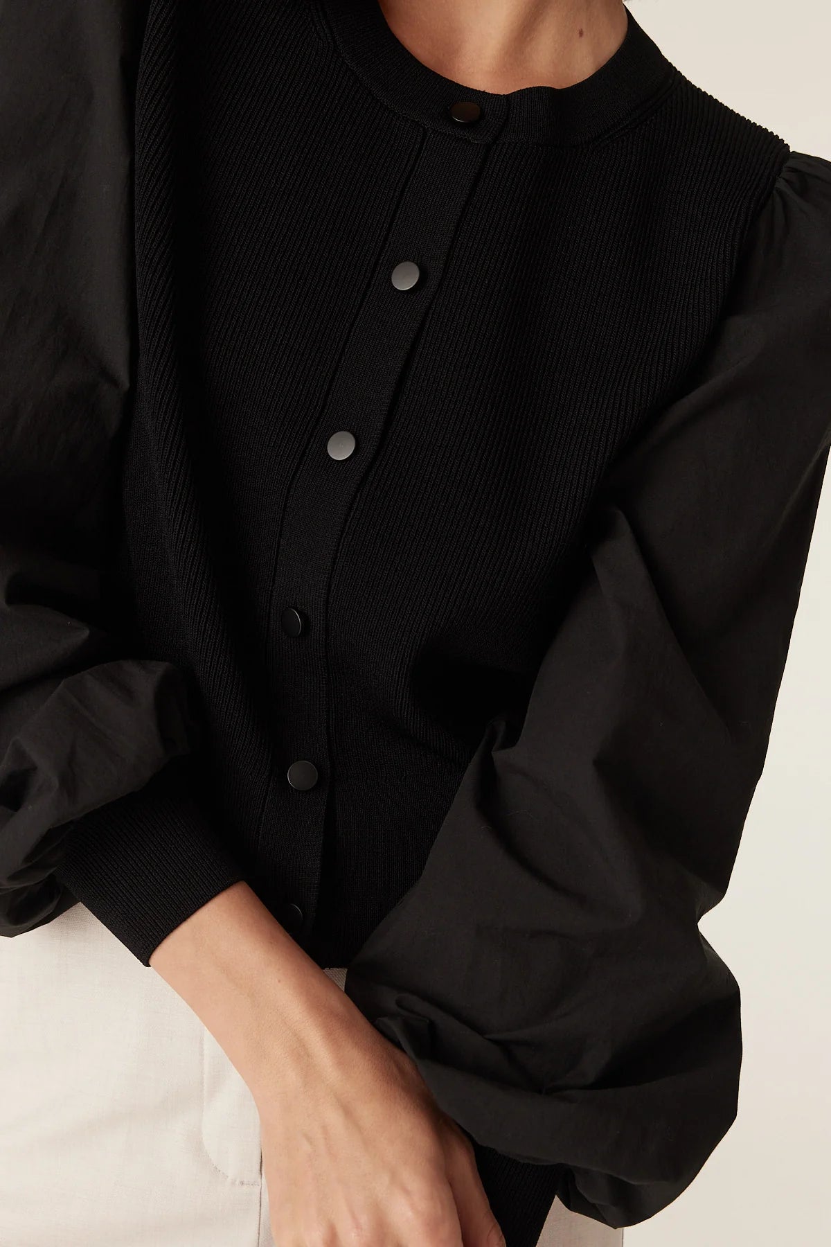 Close-up of the button placket and crew neckline on the Cable Melbourne Crepe Spring Cardigan in Black