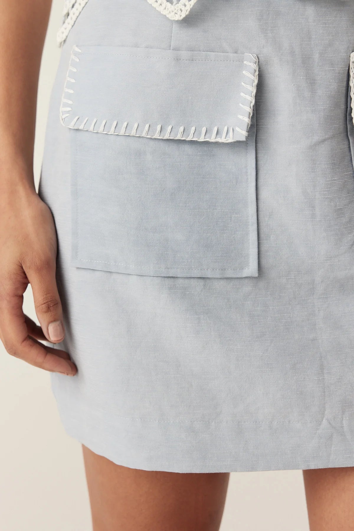 Cable Melbourne Leona Skirt in Ice Blue - close-up of the patch pocket with blanket stitch trim
