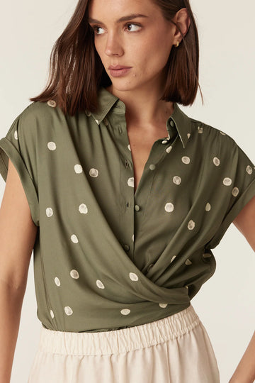 Close-up of the wrap and tie detail on the Cable Melbourne Muse Spring Blouse in Green Spot print
