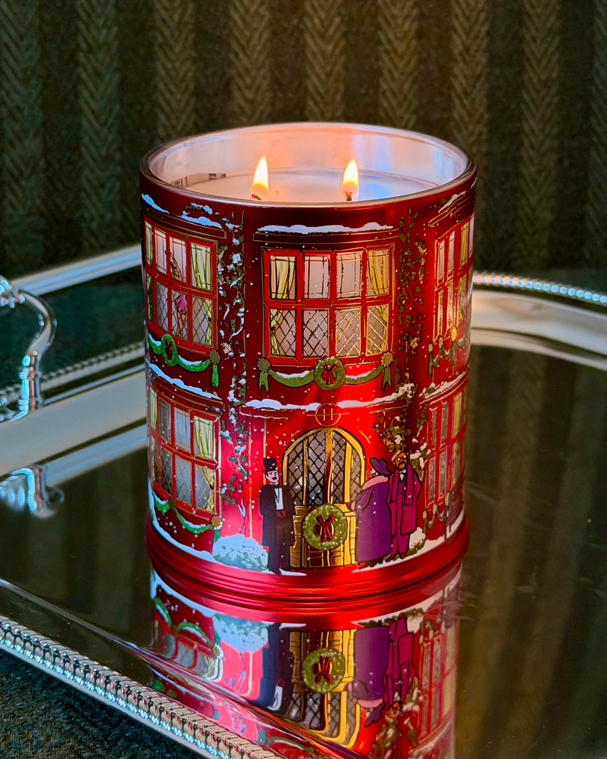 Glasshouse Fragrances Night Before Christmas Candle glowing on a mirrored tray