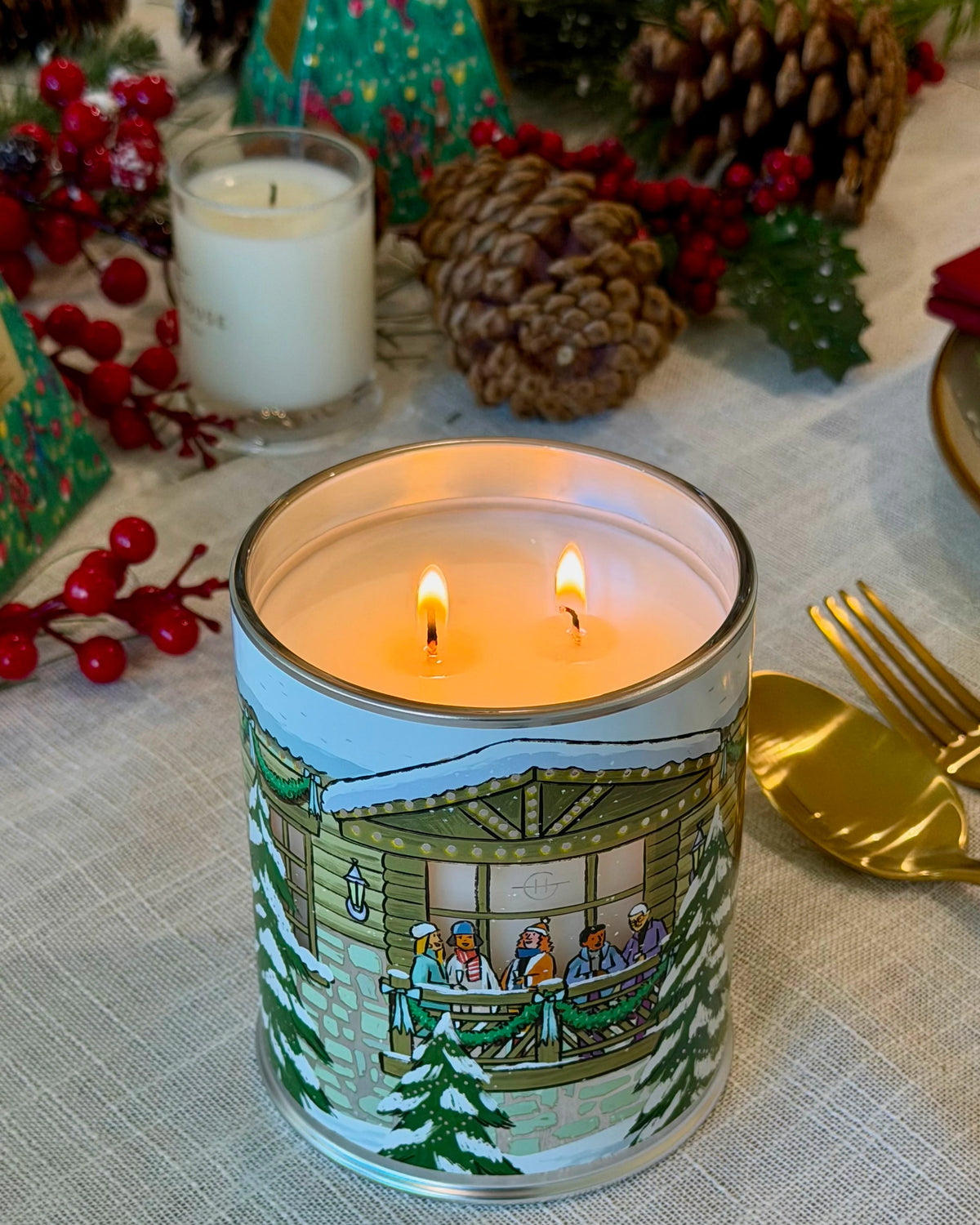 Glasshouse Fragrances White Christmas Candle lit on a festive dinner table