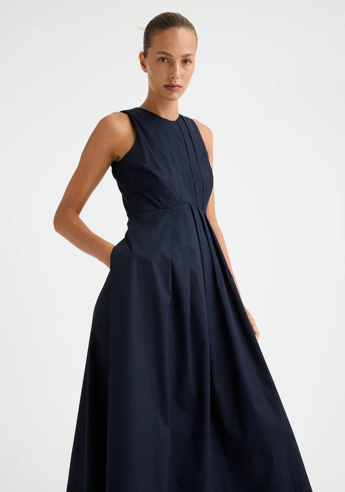 Morrison Maddison Dress in Navy, worn - three-quarter view of the fitted bodice