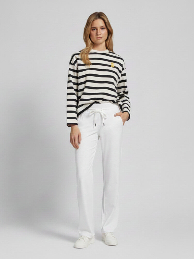 Model wearing Raffaello Rossi Candice Straight Pant in White with a striped top, front view