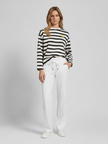 Model wearing Raffaello Rossi Candice Straight Pant in White with a striped top, front view