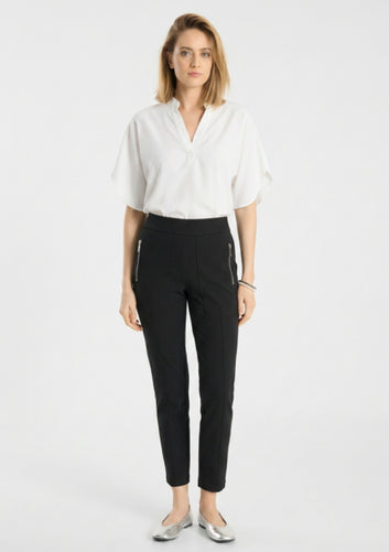 Model wearing Raffaello Rossi Corry Hightech Jersey Pant in Black with a white top and silver flats