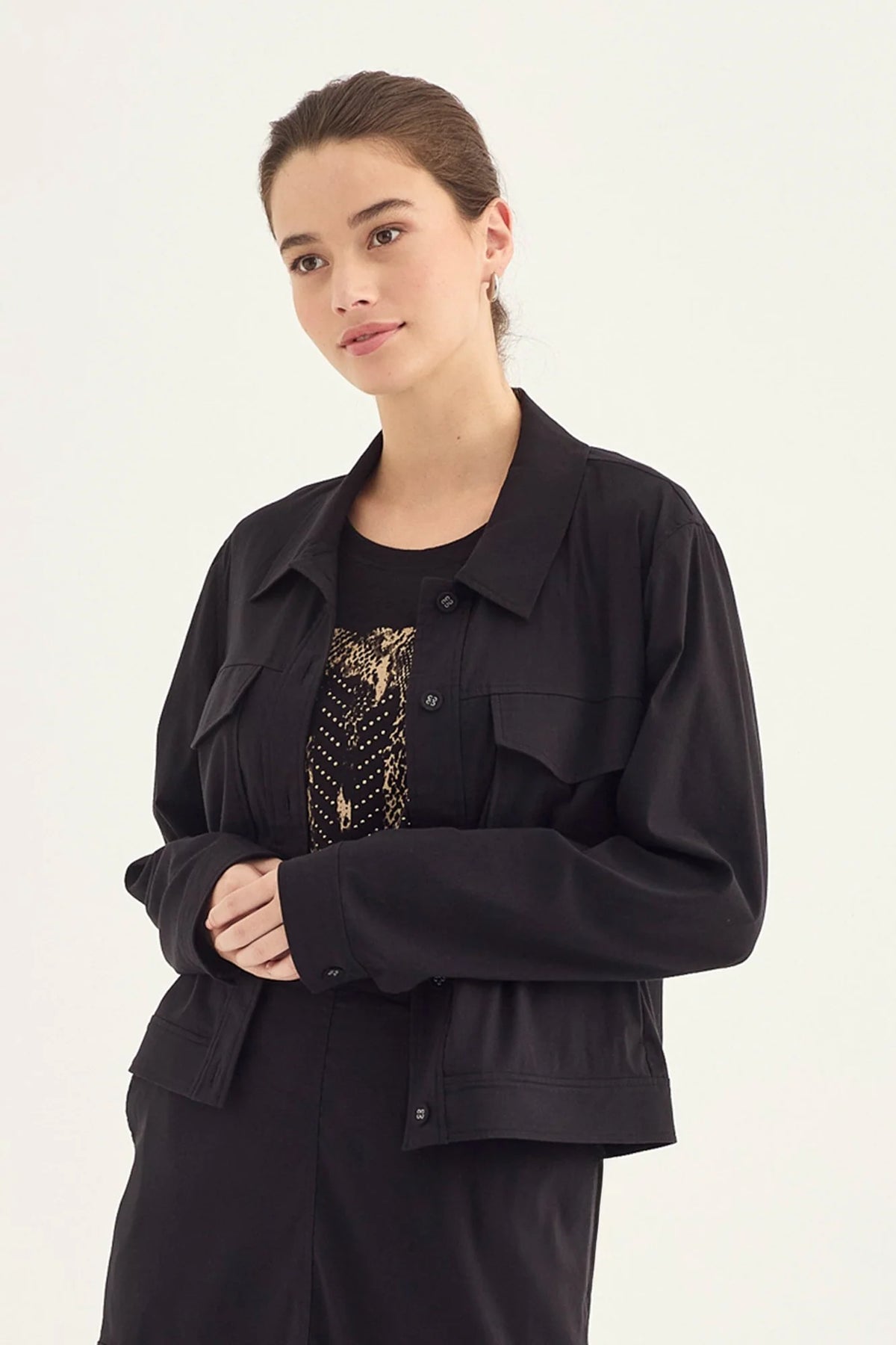Verge Acrobat Icon Jacket in Black, worn - front styled with a printed top and black skirt
