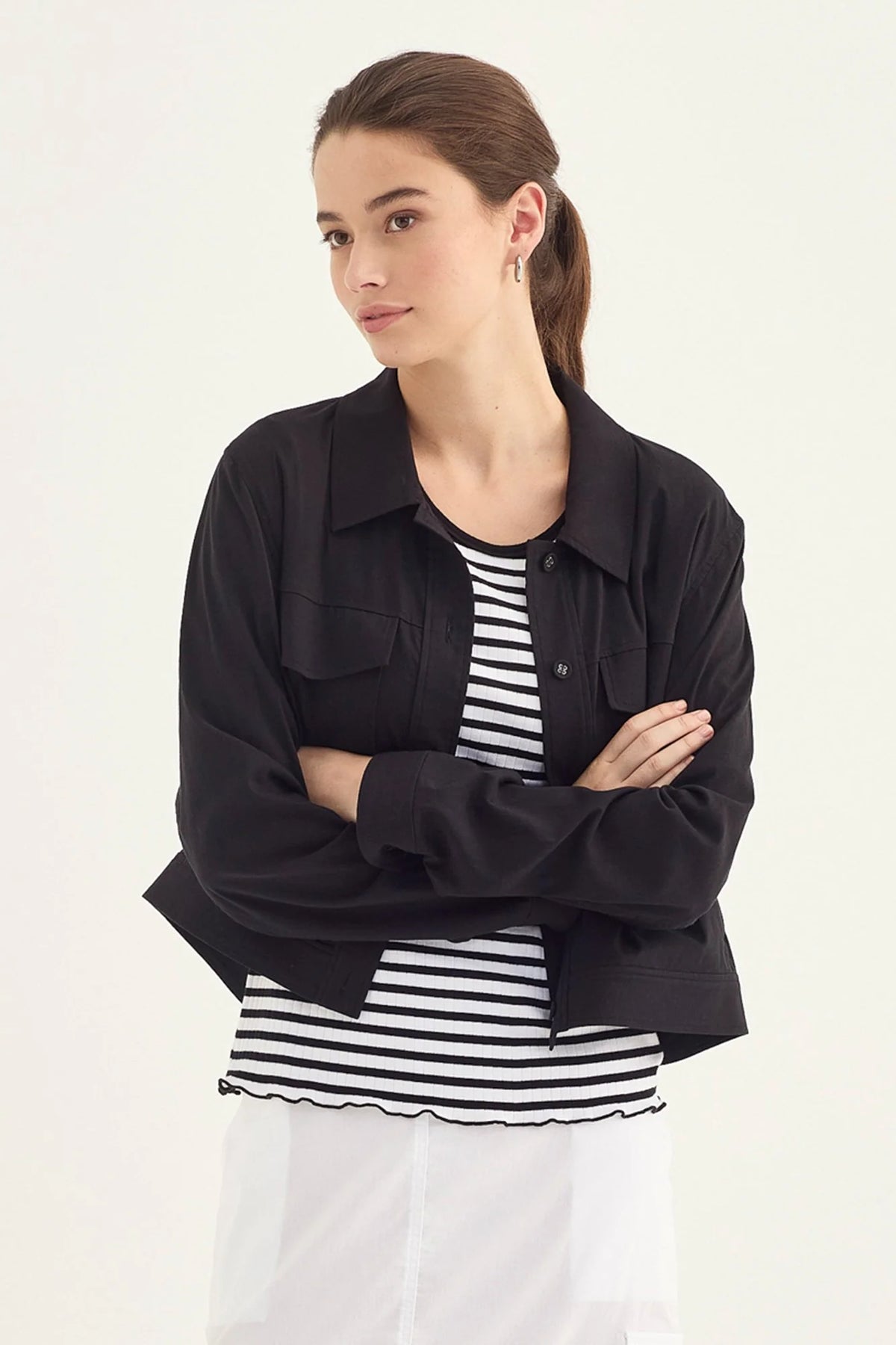 Verge Acrobat Icon Jacket in Black, worn - front styled with a striped tee and white skirt